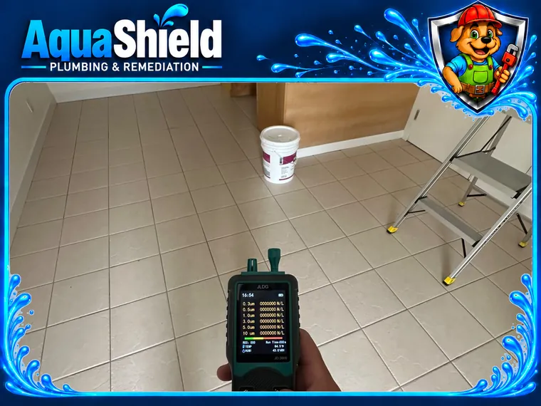 A handheld particle counter held up in the kitchen before work begins