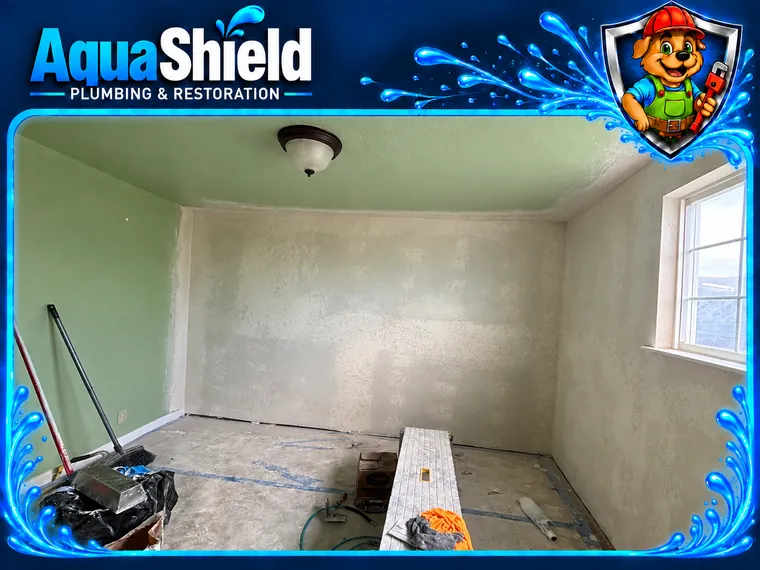 The bedroom with the walls closed up and textured, tools and a work bench on the protected floor